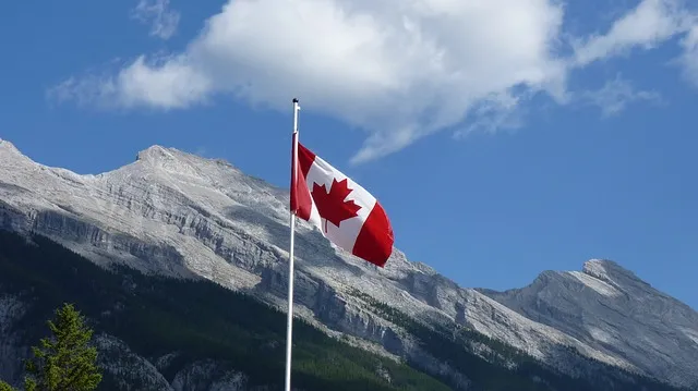 Panoramic view of Canadian landscape with lake and forests symbolizing opportunities for immigrants